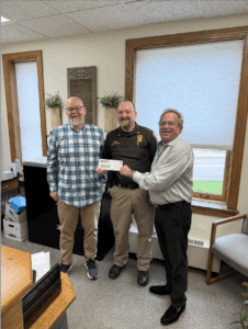 Dickinson County receives dividend with Sheriff Aaron Rochon and Administrator Brian Bousley accepting