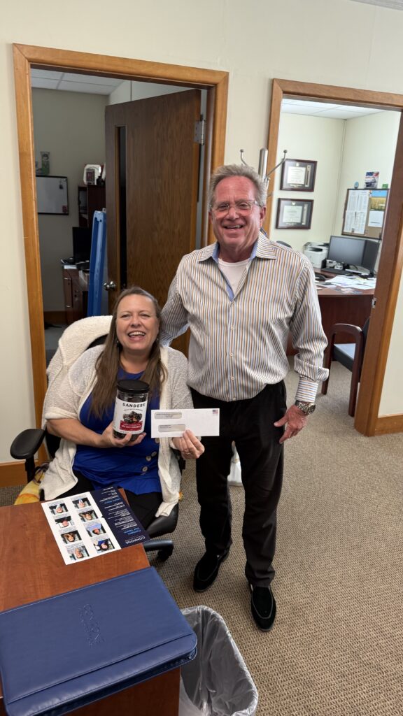 Sherry DuPont of Menominee County receives a dividend check